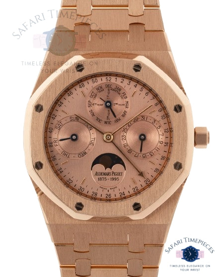 Rose gold watch with detailed face on a white background, branded 'Audemars Piguet'.
