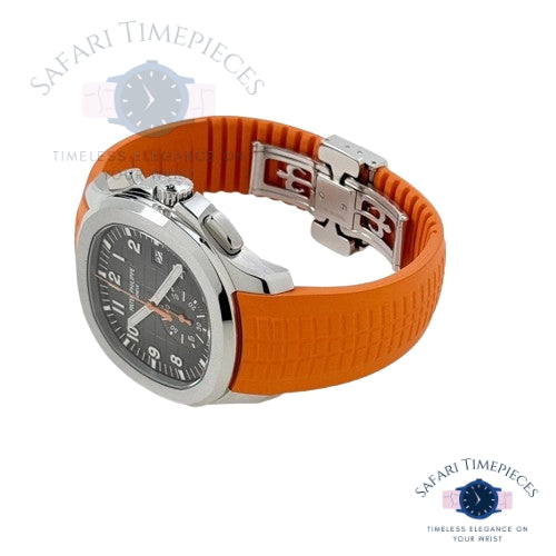 Watch with orange strap and silver case on a white background, branded 'Safari Timepieces'.