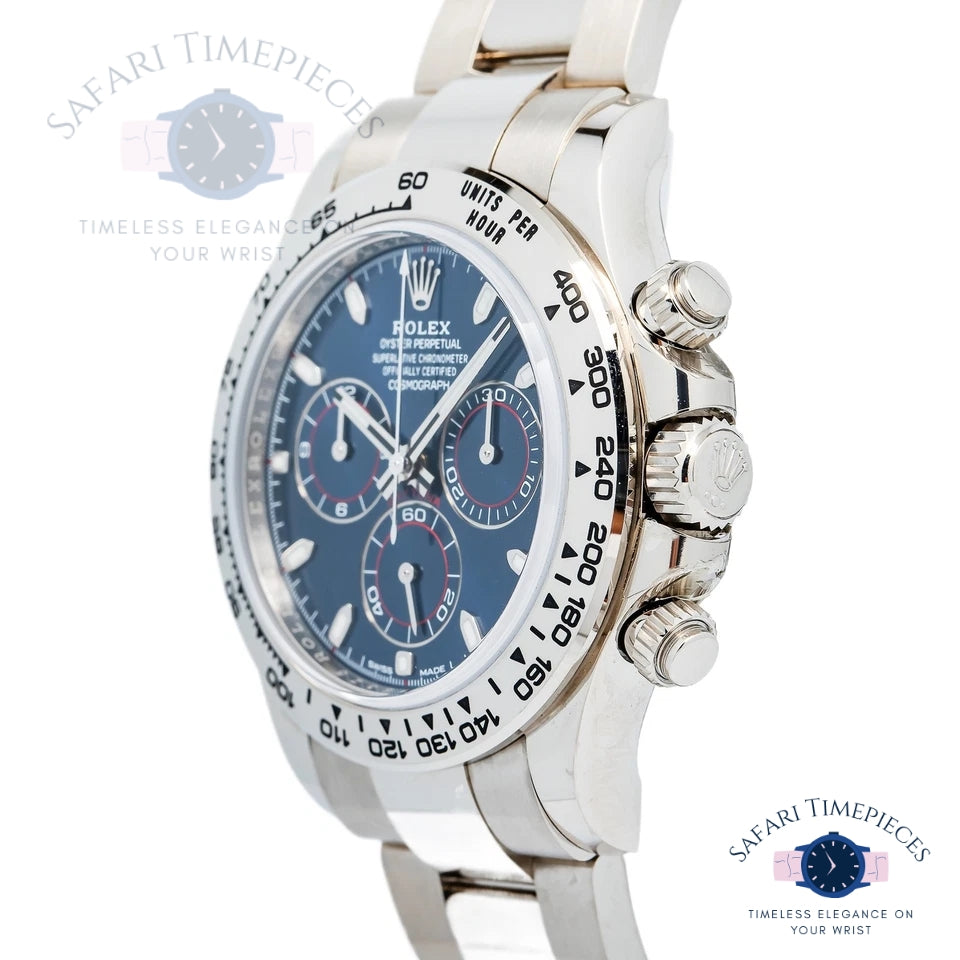 Silver Rolex watch with blue dial on a white background, featuring 'Safari Timepieces' branding.