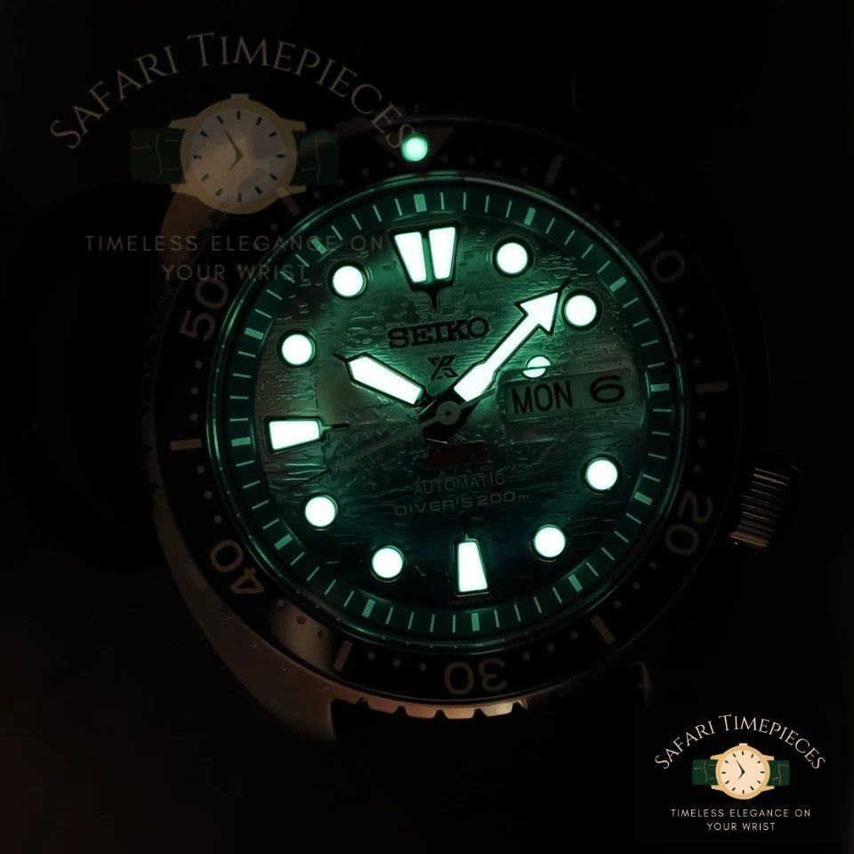 Seiko watch with green glow-in-the-dark face on a black background
