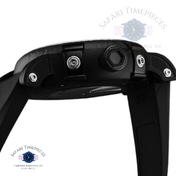 Close-up of a black watch case with visible screws on a white background, featuring the Safari Timepieces logo.