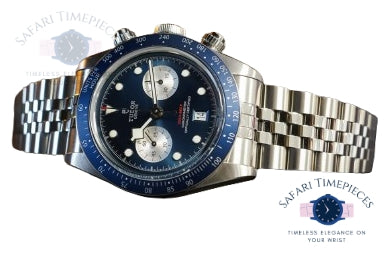 Tudor Silver watch with blue face on a white background, branded 'Safari Timepieces'.