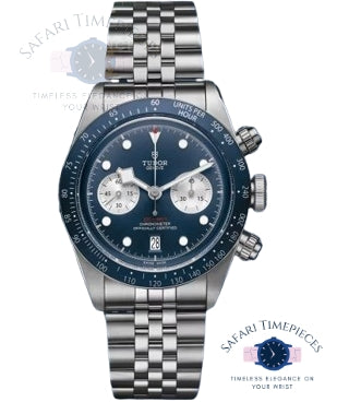 Tudor watch with blue face and silver case on a white background
