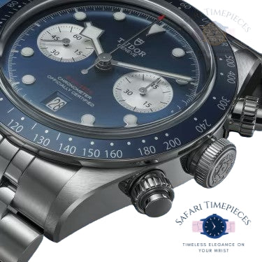 Close-up of a luxury watch with a blue face and silver case, featuring the Tissot brand.