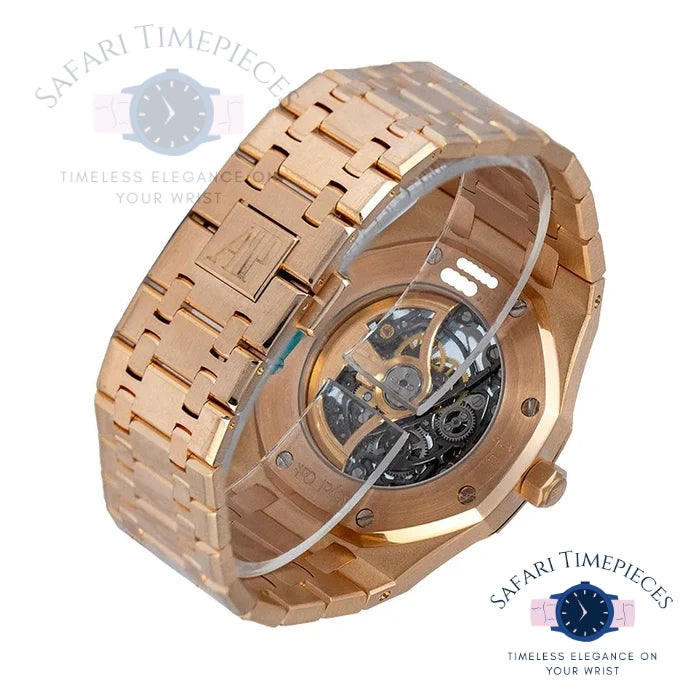 Gold watch with visible mechanical components on a white background, branded 'Safari Timepieces'.